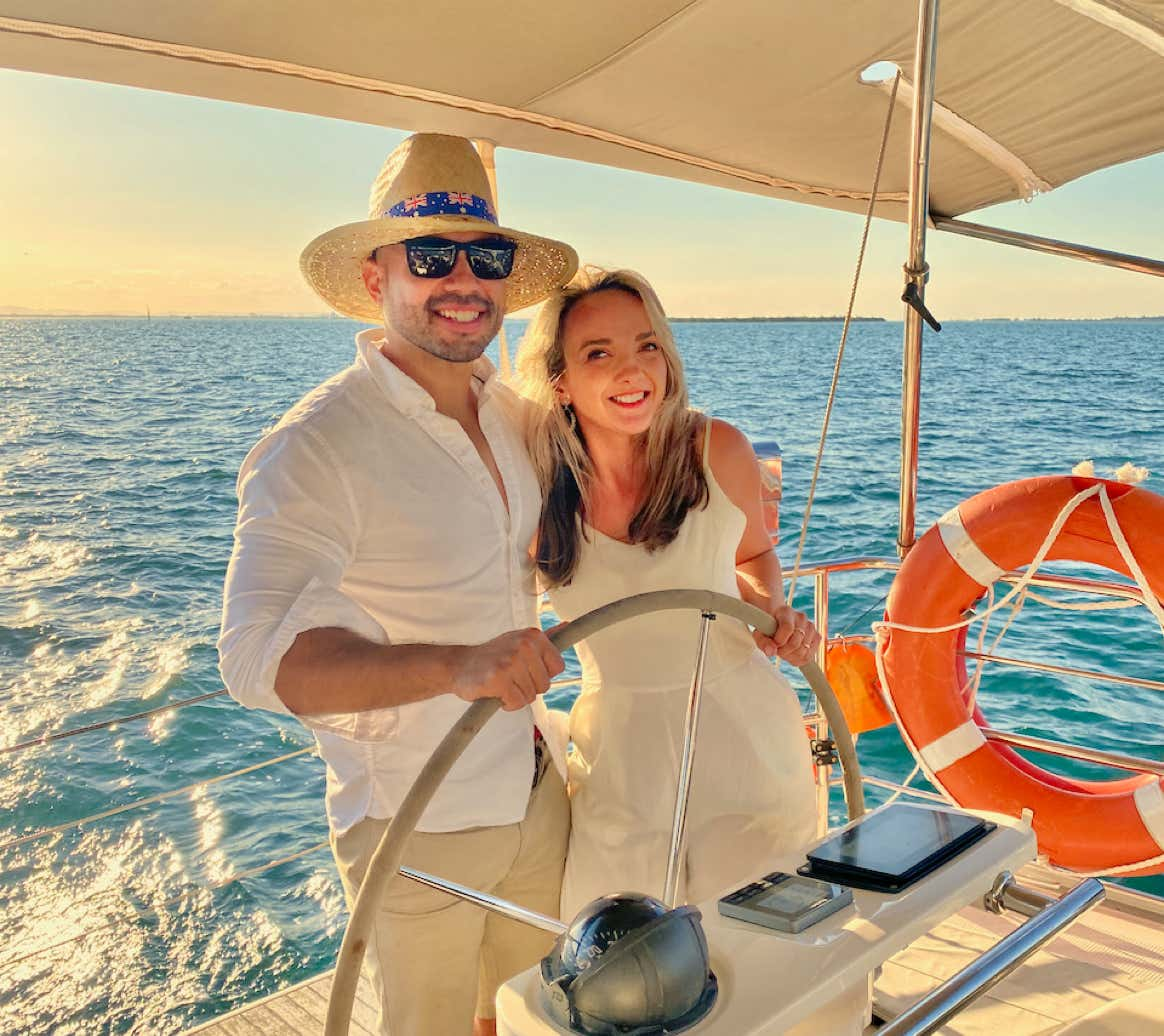 Couple on a sunset sail on a private yacht charter on Curlew Escape, Moreton Bay, Brisbane.