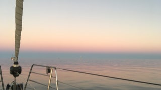 Beautiful Dusk with calm water  on  Sailing Yacht Curlew Escape, available for private yacht charters on Moreton Bay, Brisbane.