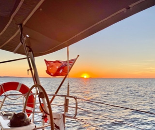 Sunset over water on a sunset sail on a private yacht charter on Curlew Escape, Moreton Bay, Brisbane.