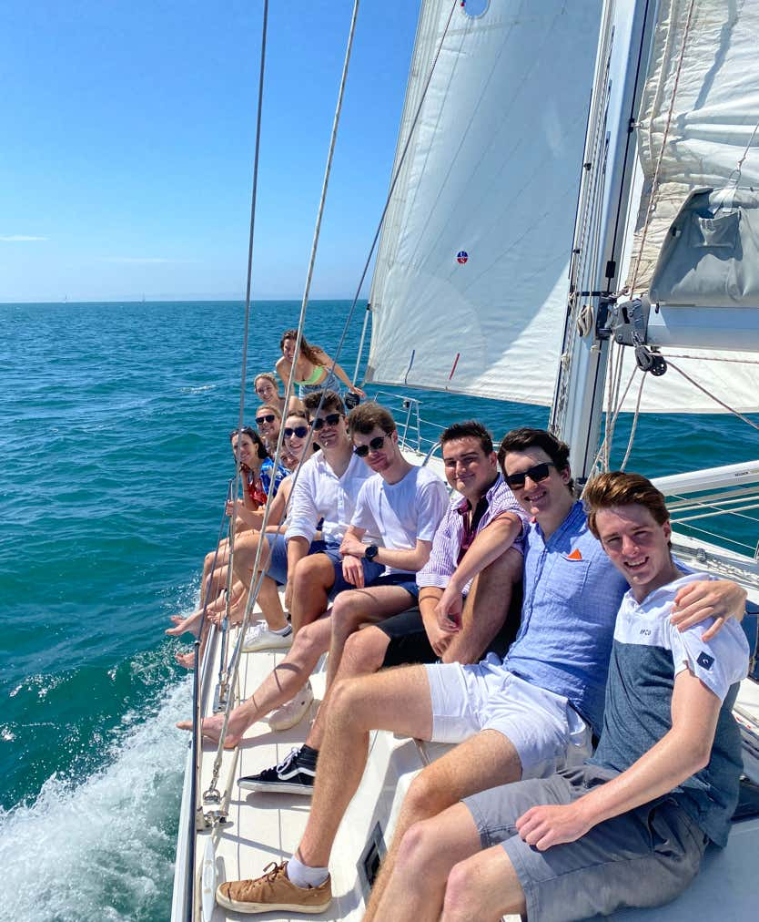 Friends along the rail on while sailing on a private yacht charter, Moreton Bay.