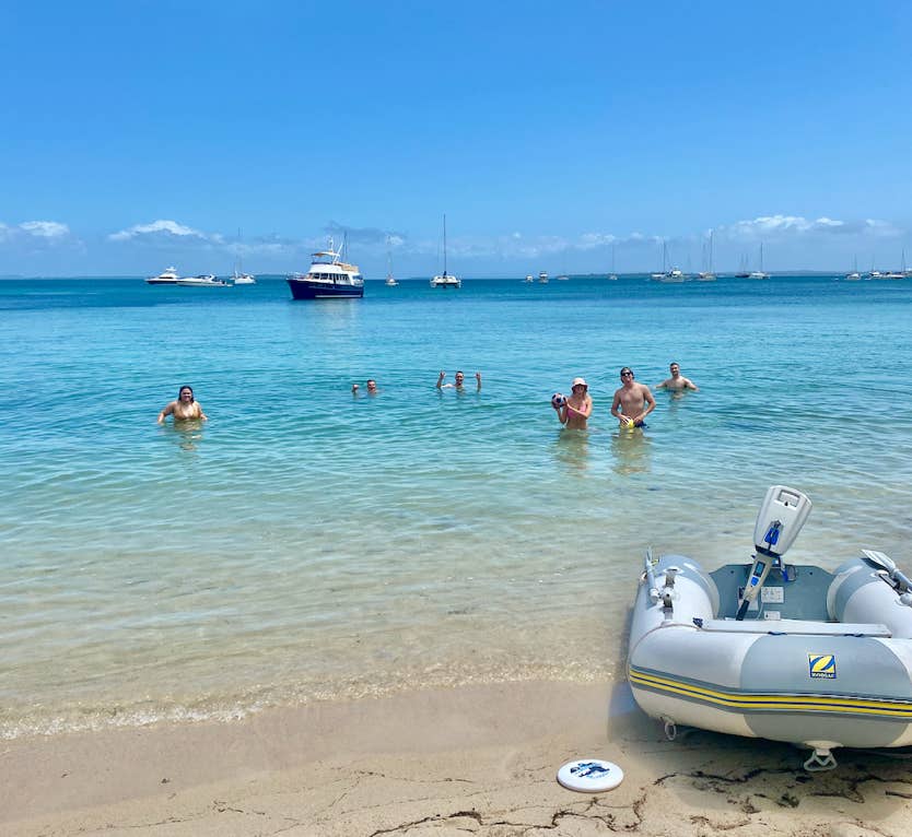 Guests enjoying a swim from the beach at Peel Island, Moreton Bay.