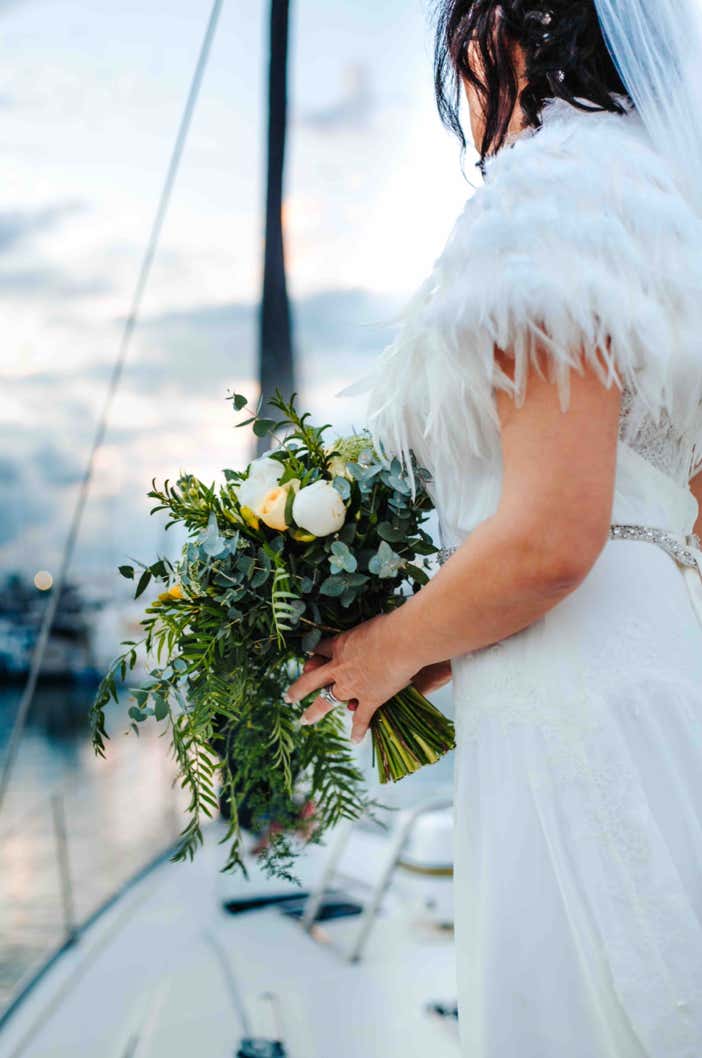 Bride being delivered to her reception on a private yacht charter on Curlew Escape, Moreton Bay, Brisbane.