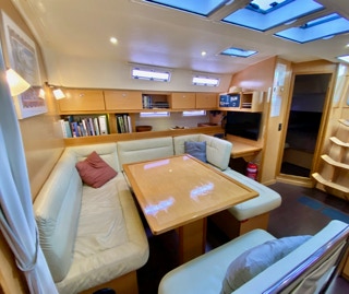 Comfortable leather sofa in the saloon on Sailing Yacht Curlew Escape, available for private yacht charters on Moreton Bay, Brisbane.