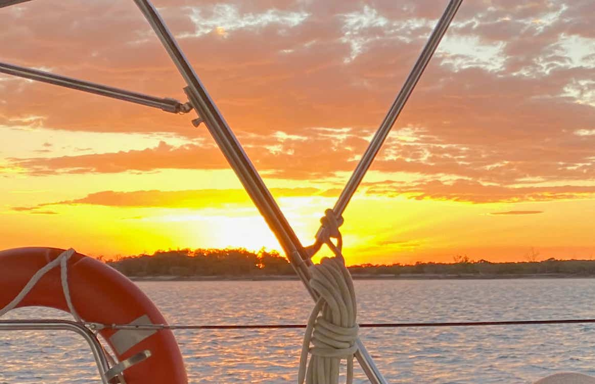 Sunset over water on Sailing Yacht Curlew Escape, available for private yacht charters on Moreton Bay, Brisbane.