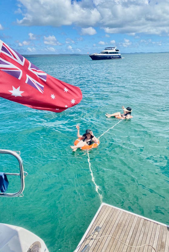 Birthday girl and friend floating in the life rings at Peel Island.